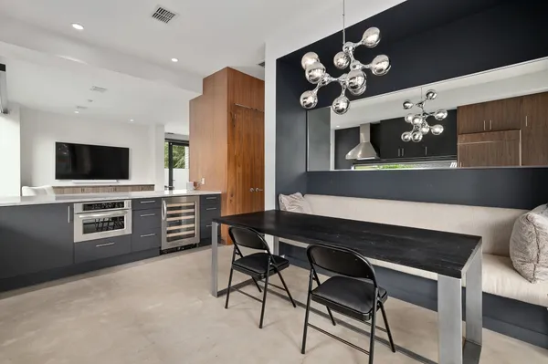 a kitchen with stainless steel appliances kitchen island granite countertop a stove a sink and a microwave