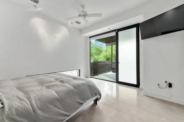 a large bed sitting in a room next to a window