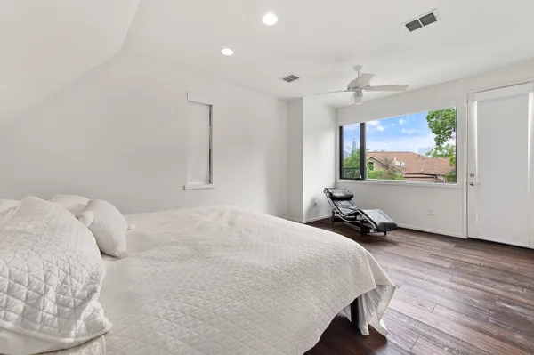 a bed room with a bed and a flat tv screen