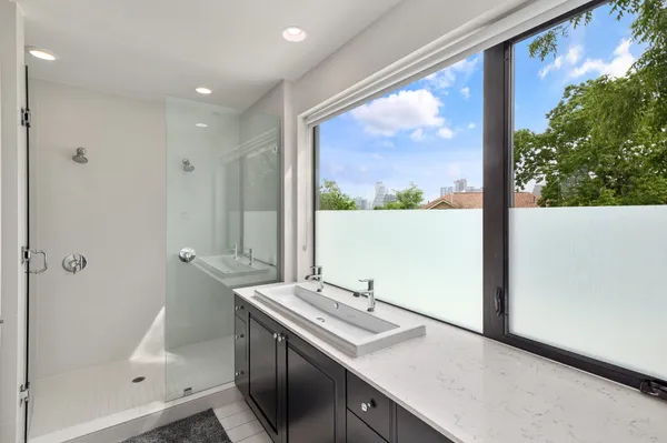 a view of bathroom with a sink and mirror