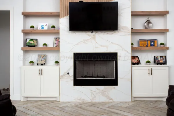 a living room with a fireplace and a flat screen tv