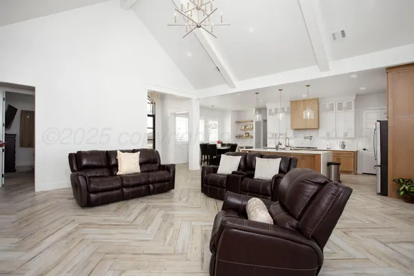 a living room with furniture and kitchen view
