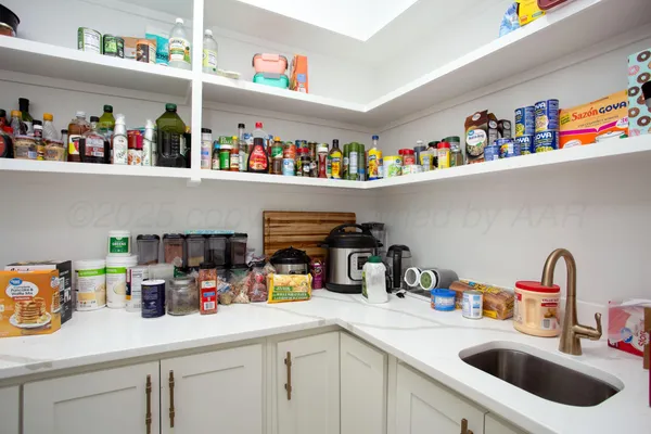 a kitchen with a sink a counter and a refrigerator