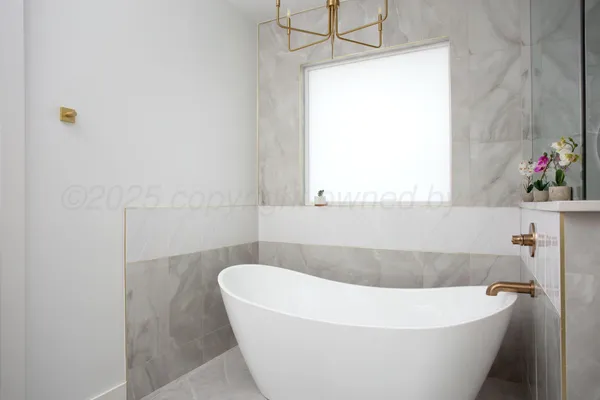 a white bath tub sitting in a bathroom
