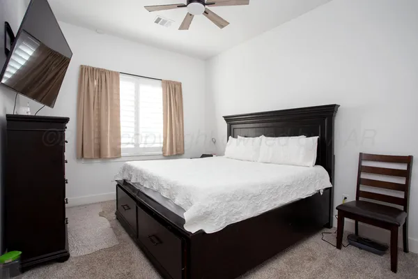 a bedroom with a bed and a television