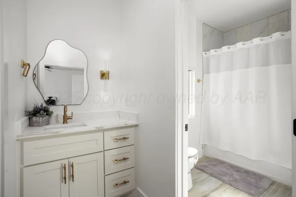 a bathroom with a sink vanity and a mirror