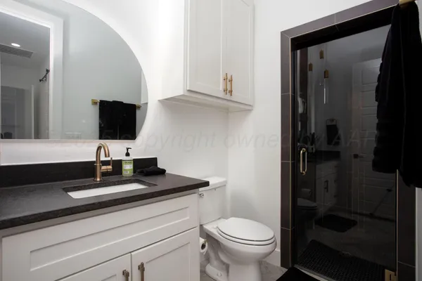 a bathroom with a toilet sink and shower