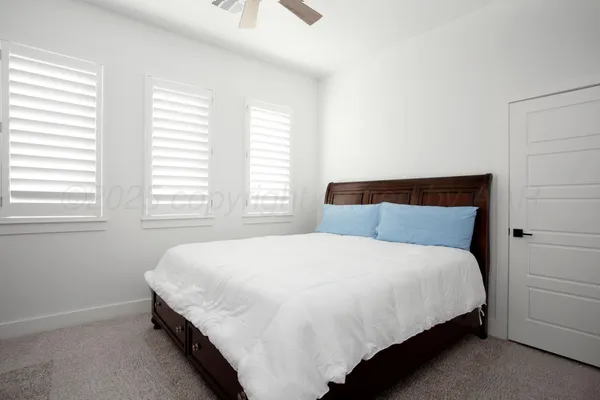 a bedroom with a bed and window