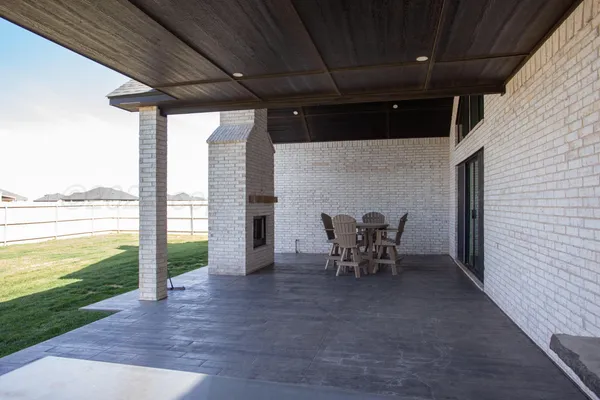 a view of a porch with furniture and a yard