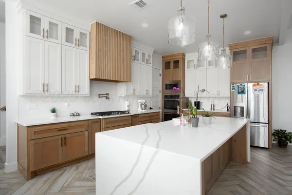 a large kitchen with kitchen island a sink stainless steel appliances and cabinets