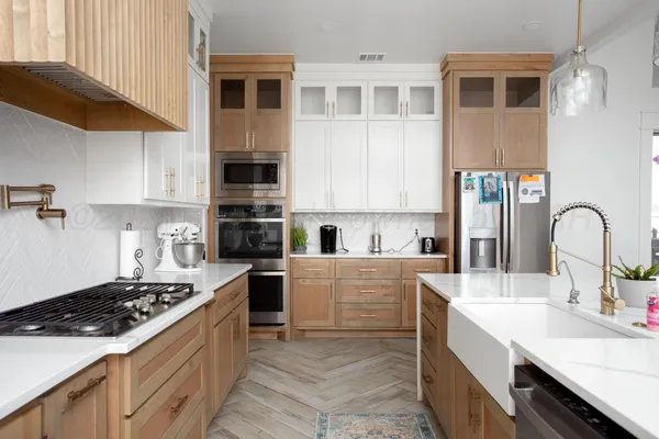 a kitchen with stainless steel appliances granite countertop a stove and a sink