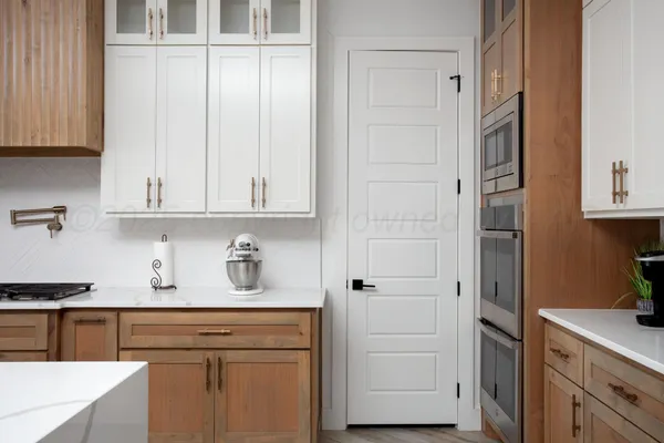a kitchen with stainless steel appliances white cabinets and a refrigerator