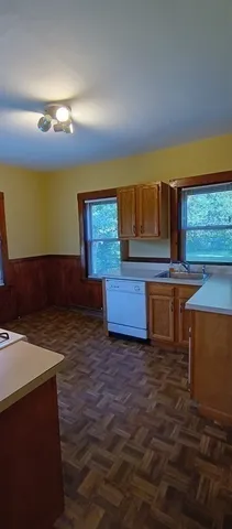 a kitchen with granite countertop a sink and a stove