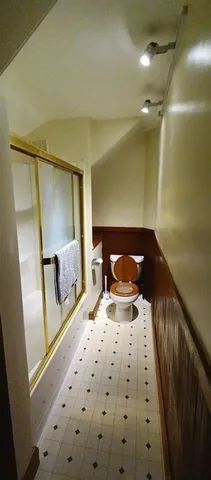 a bedroom with a bed and a mirror