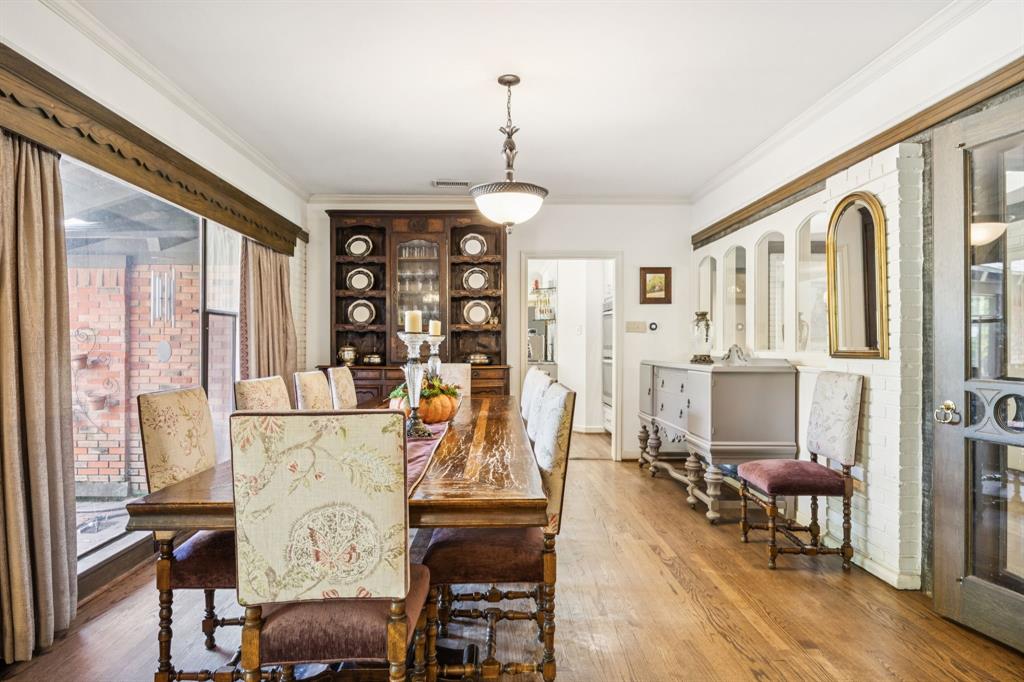 4549 Walnut Hill Lane Dallas, TX 75229 - Photo 11 of 40 a living room with furniture a dining table and a chandelier