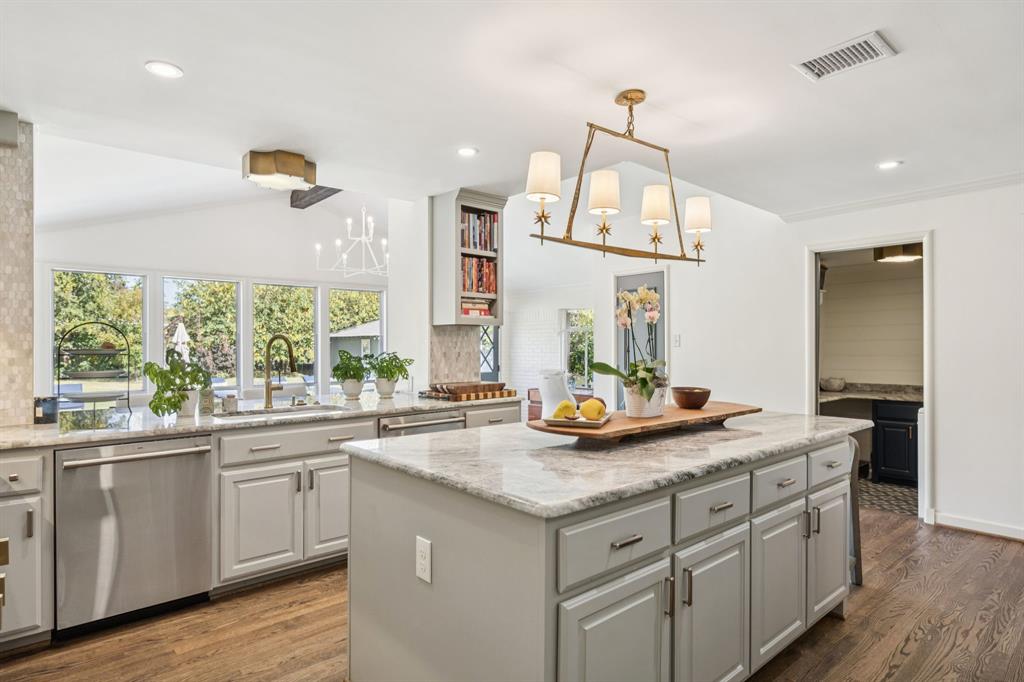 4549 Walnut Hill Lane Dallas, TX 75229 - Photo 13 of 40 a kitchen with sink cabinets and wooden floor