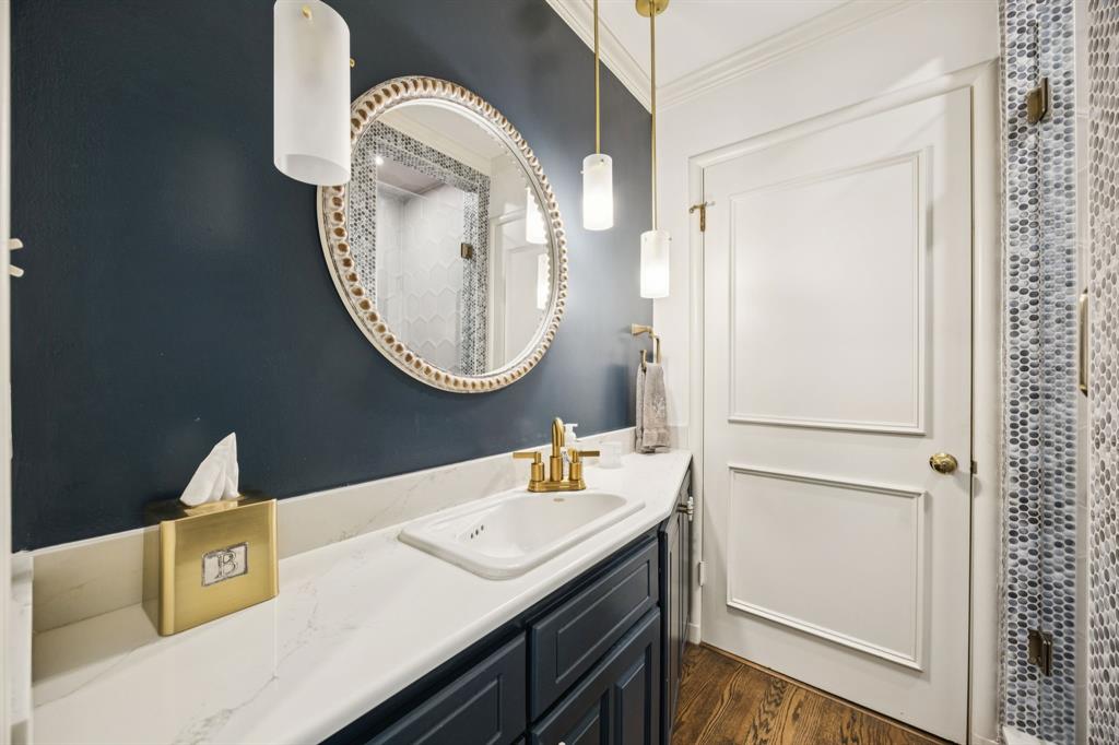 4549 Walnut Hill Lane Dallas, TX 75229 - Photo 19 of 40 a bathroom with a sink and a mirror