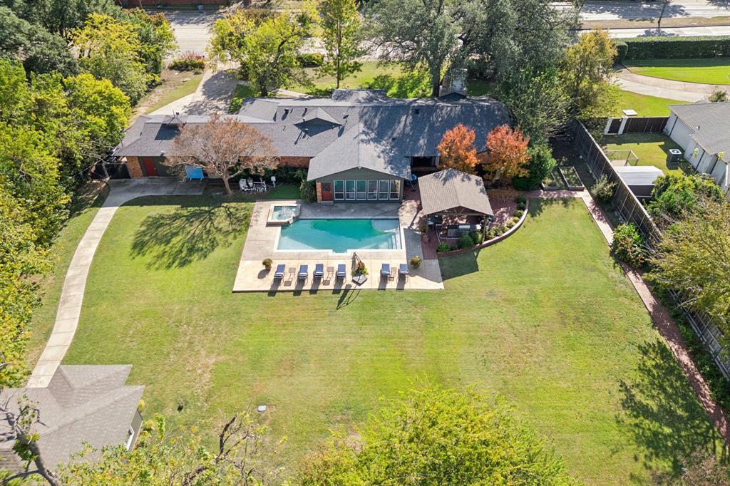 4549 Walnut Hill Lane Dallas, TX 75229 - Photo 2 of 40 a swimming pool with some tall trees