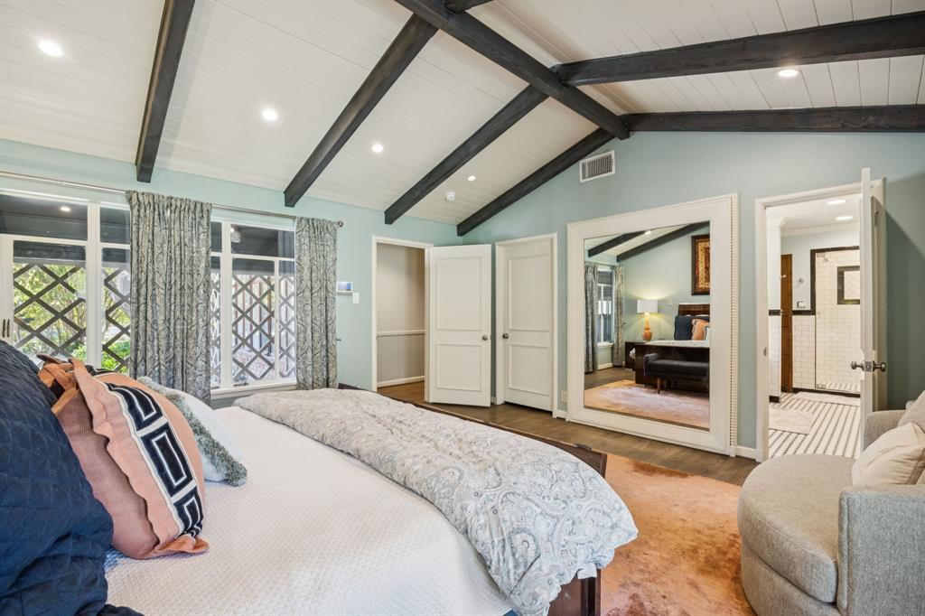 4549 Walnut Hill Lane Dallas, TX 75229 - Photo 24 of 40 a bedroom with a bed next to a window