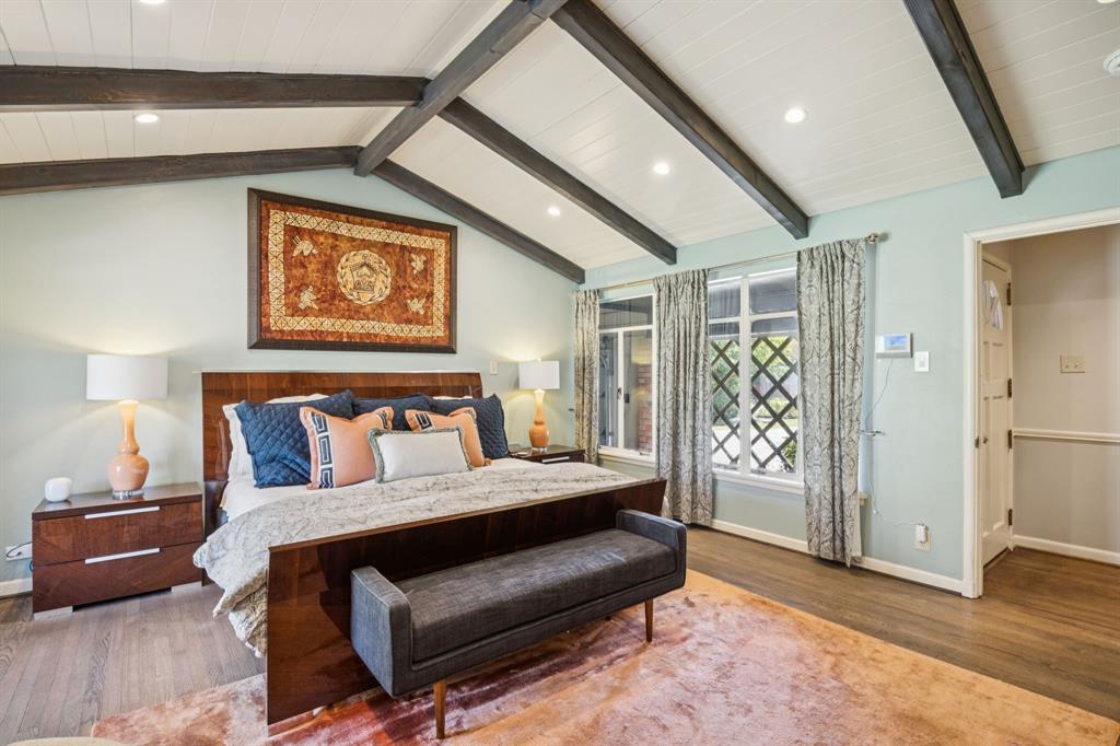 4549 Walnut Hill Lane Dallas, TX 75229 - Photo 25 of 40 a bedroom with a bed and wooden floor