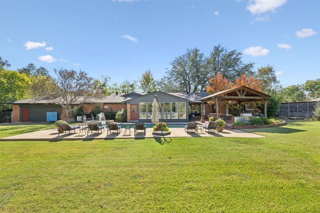 4549 Walnut Hill Lane Dallas, TX 75229 - Photo 40 of 40 a view of a swimming pool with lawn chairs and a yard