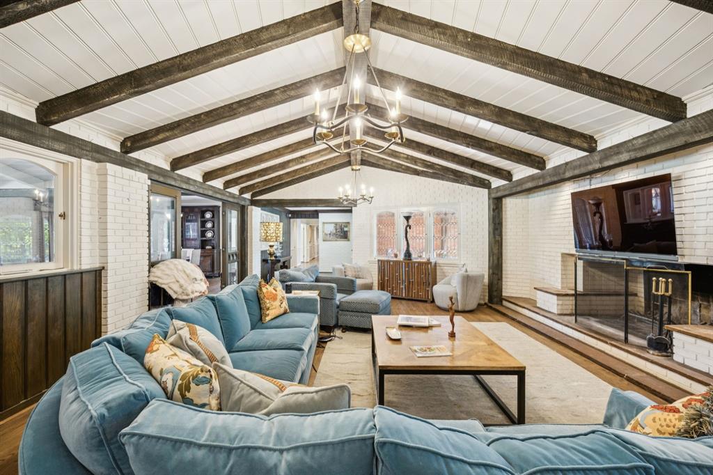 4549 Walnut Hill Lane Dallas, TX 75229 - Photo 8 of 40 a living room with furniture a flat screen tv and a large window