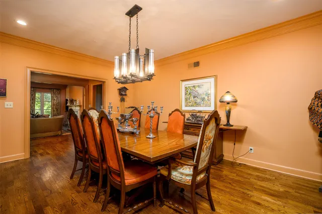 a view of a dining room with furniture and chandelier