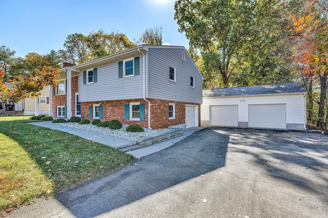 a view of a yard in front of a white house