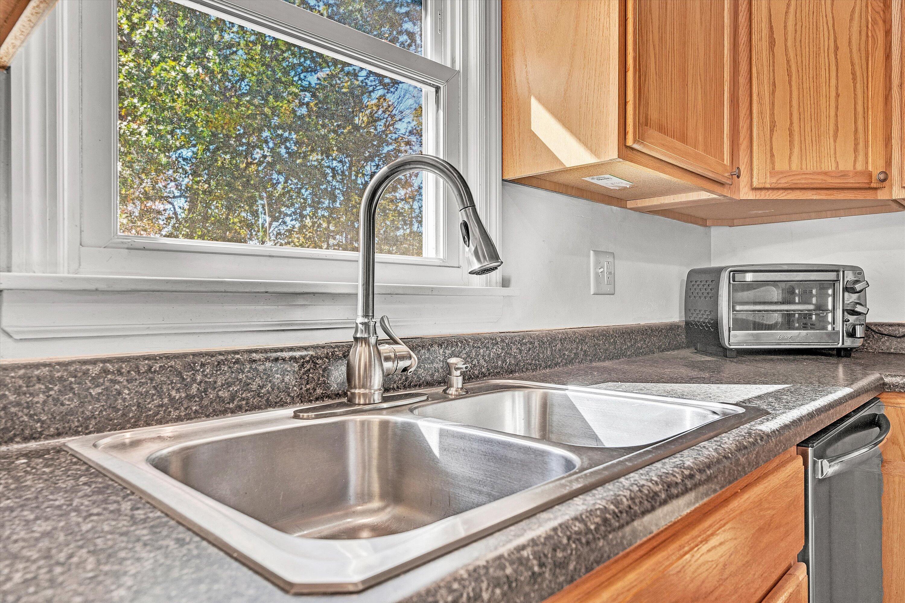 6836 Trevilian Road Roanoke, VA 24019 - Photo 18 of 47 a kitchen with granite countertop a sink and a window