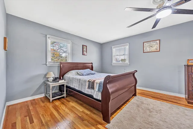 a bedroom with a bed wall painting and a window