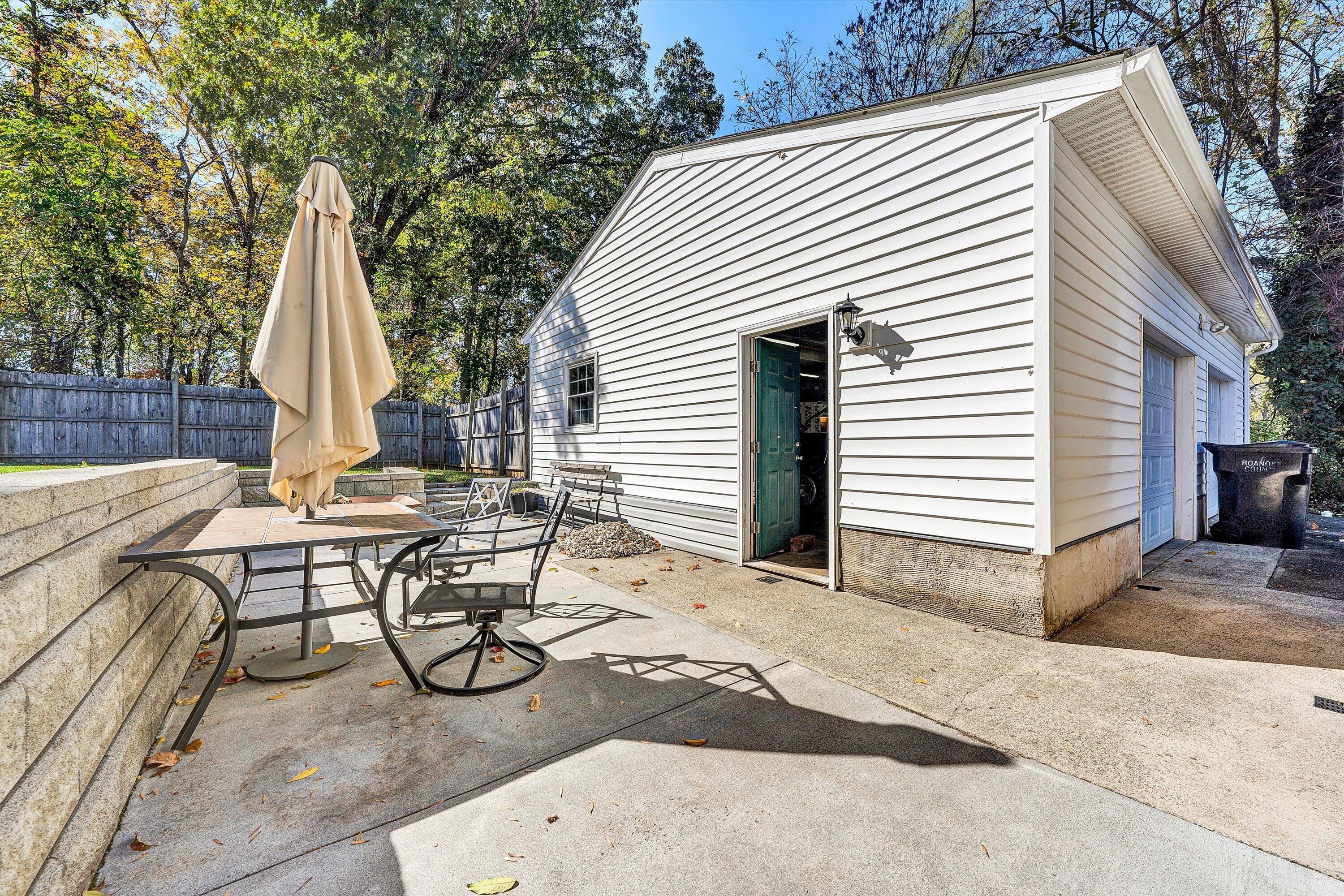 6836 Trevilian Road Roanoke, VA 24019 - Photo 33 of 47 a view of backyard with a table and chairs and a large tree
