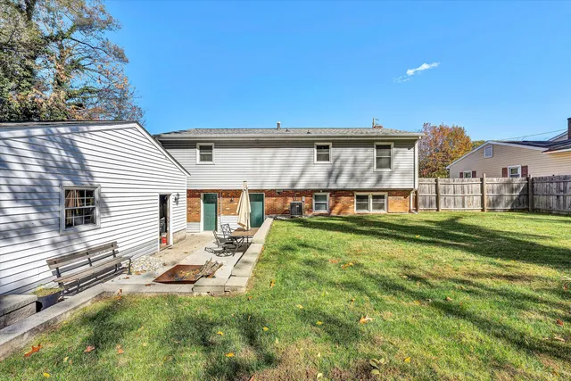 a view of a house with a yard and sitting area