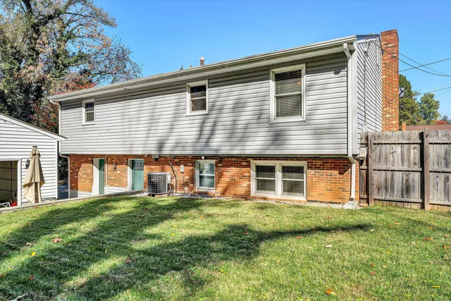 a view of a house with a big yard and large trees