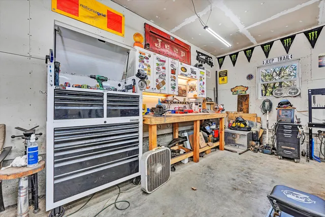a view of house with garage and yard