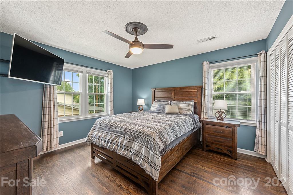 2531 Milton Road Charlotte, NC 28215 - Photo 9 of 19 a bedroom with a large bed and a flat tv screen