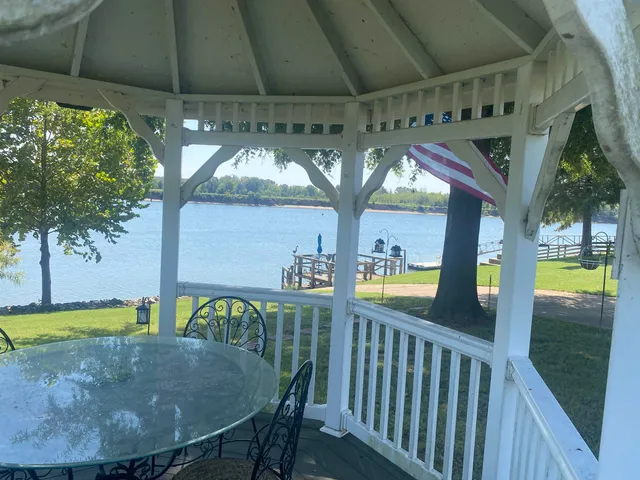 a view of a swimming pool with a patio and a yard