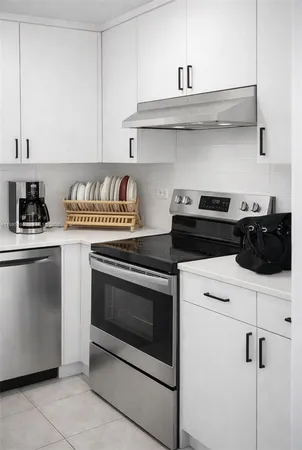 a kitchen with stainless steel appliances granite countertop a stove and a microwave