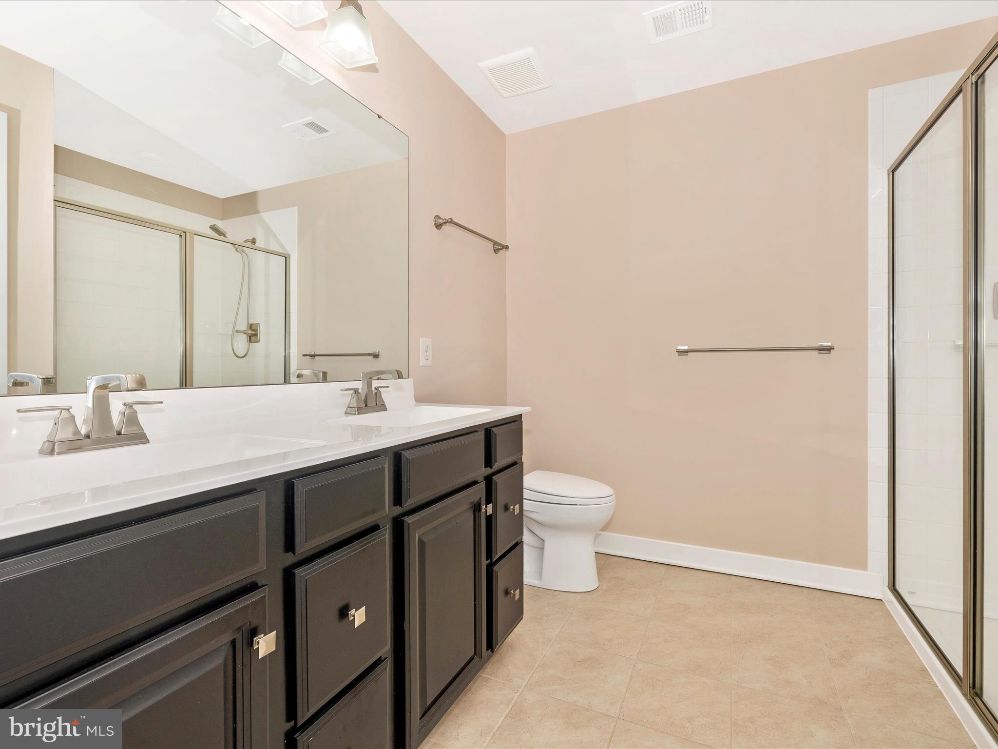 2004 Quandary Drive Frederick, MD 21702 - Photo 21 of 47 a bathroom with a sink a toilet a mirror and vanity