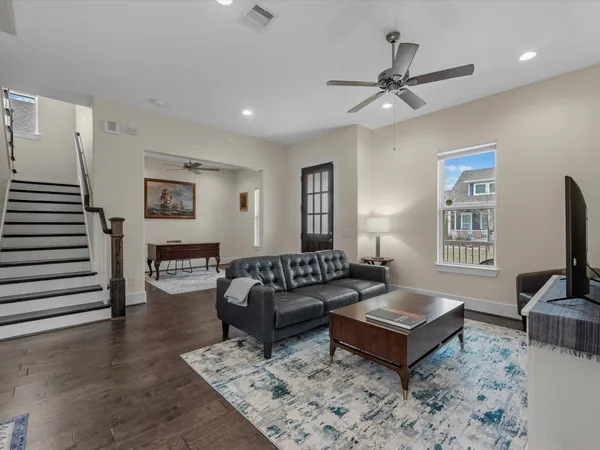 a living room with furniture a rug and a flat screen tv