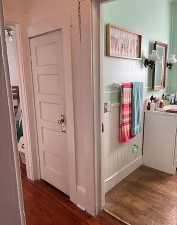 a view of a hallway with closet and workspace