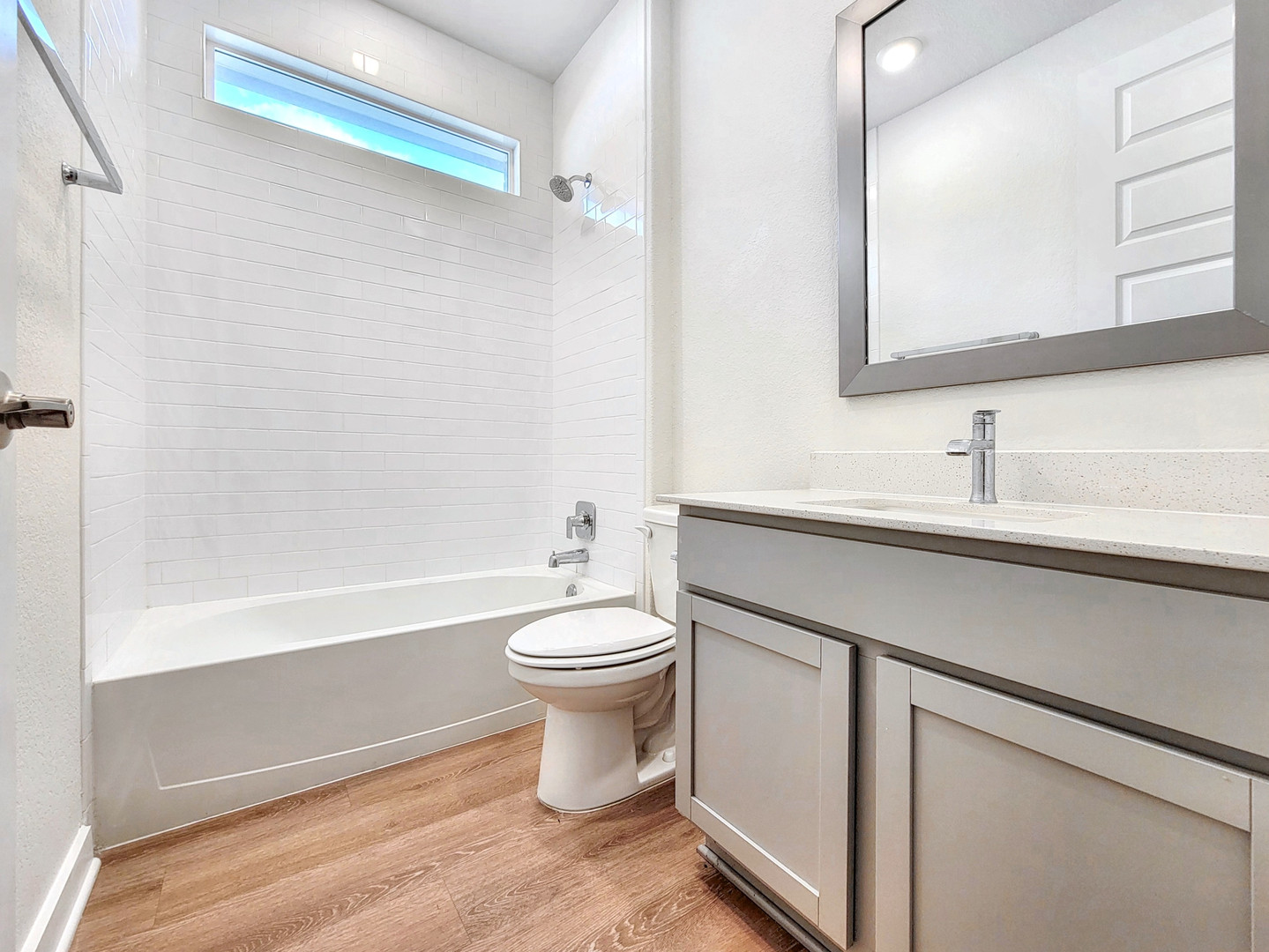 2329 Gabriels Horn Road Leander, TX 78641 - Photo 20 of 23 A well-appointed bathroom features subway tile, a convenient vanity, and rich wood flooring.