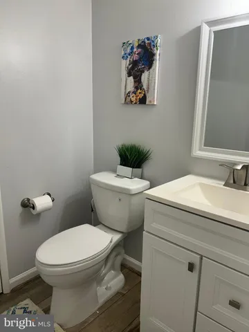 a white toilet sitting next to a bathroom sink