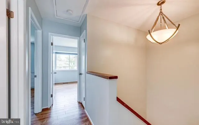 a view of a room with wooden floor and white walls