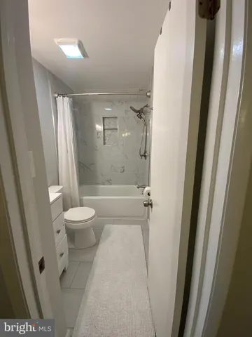 a bathroom with a shower a toilet and a sink