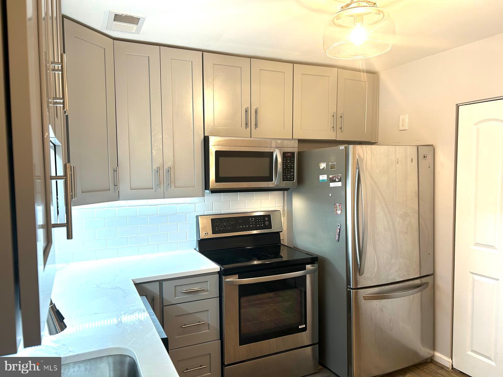 1805 Westwind Way, Unit 55 McLean, VA 22102 - Photo 6 of 30 a kitchen with a refrigerator sink and microwave