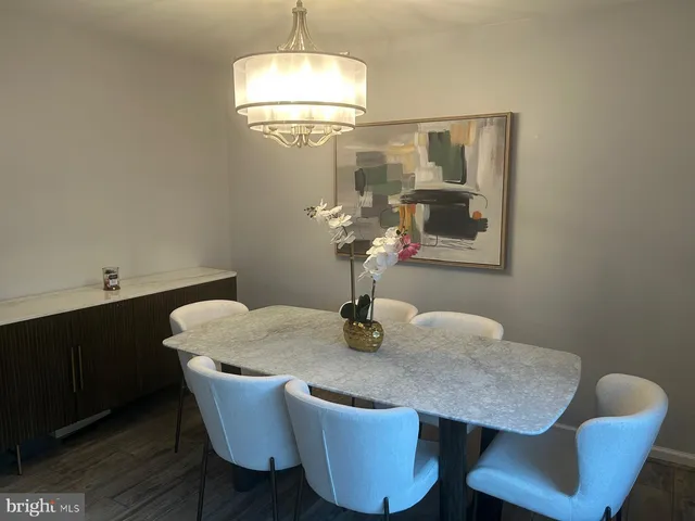 a dining room with furniture and chandelier