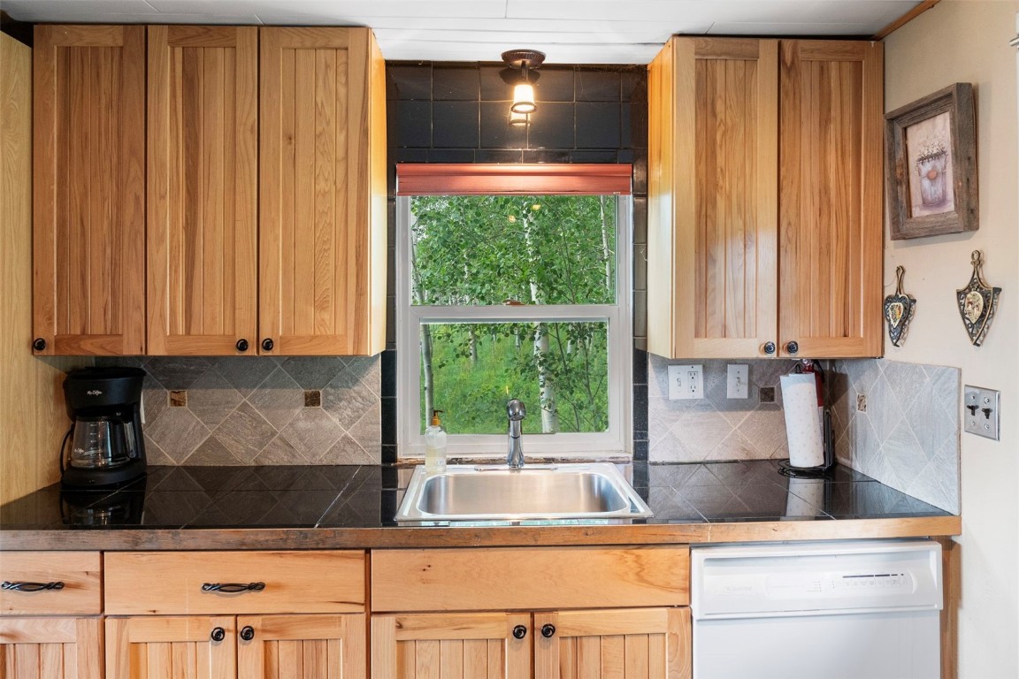 473 J Road Silverthorne, CO 80498 - Photo 10 of 38 a kitchen with a sink and a large window