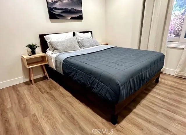 a bedroom with bed and a window