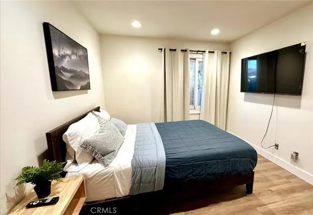 a bedroom with a bed and a flat screen tv