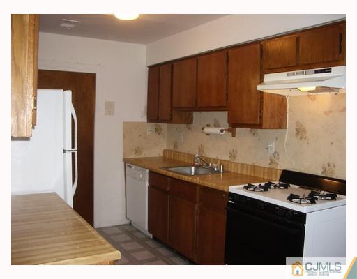 1537 Raspberry Court Edison, NJ 08817 - Photo 3 of 10 a kitchen with stainless steel appliances a sink a stove a refrigerator a cabinets and wooden floor